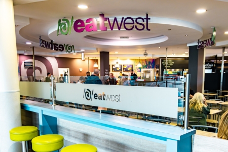 Image of passengers sitting in the Eatwesr restaurant in the airport