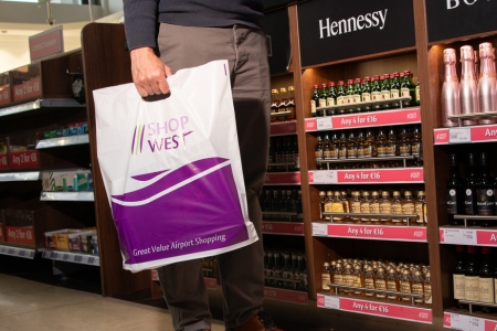 Image of a man holding a shopwest shopping bag